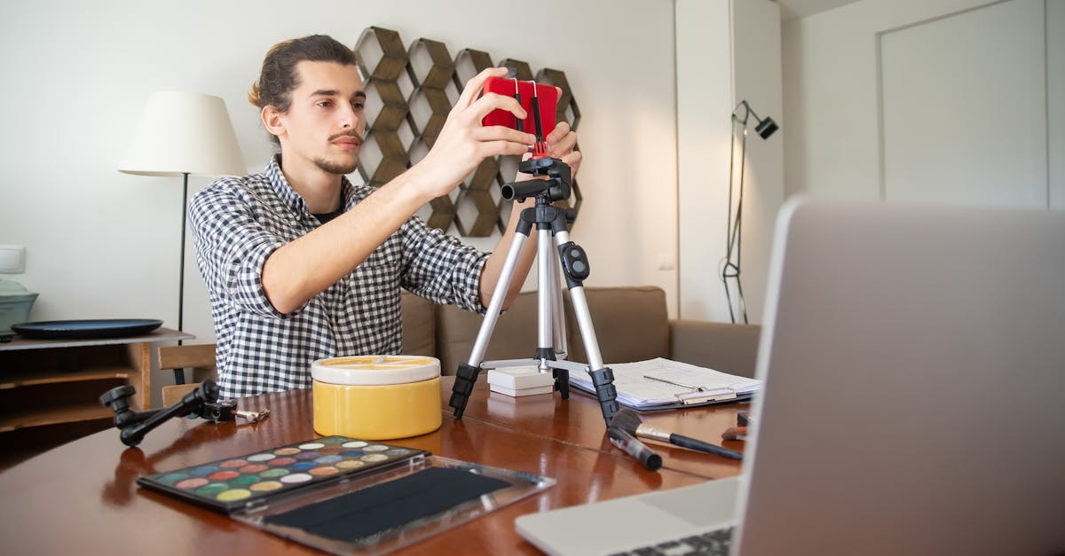 A male vlogger adjusts his camera on a tripod, preparing for a video shoot in a stylish home studio. Digital Marketing Services in Pune